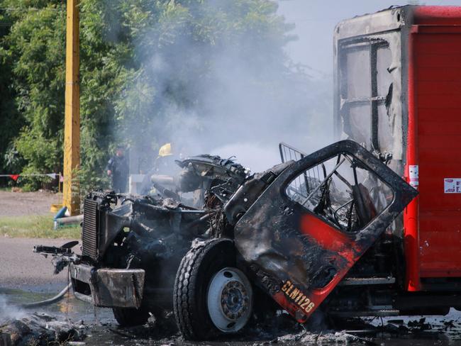 A burned truck is seen on the streets of Culiacan, Sinaloa State, Mexico, on September 11, 2024. Elements of Mexico's National Guard were deployed in the state of Sinaloa, in the northwest of the country, amid an escalation of violence that authorities attribute to internal struggles within the Sinaloa cartel following the capture of its leader, Ismael "Mayo" Zambada. (Photo by Ivan MEDINA / AFP)