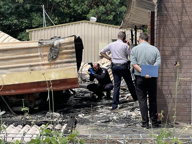 Detectives and scenes of crime officers on scene at a Nebo home that was gutted by a fire that also destroyed a vehicle. Picture: Janessa Ekert