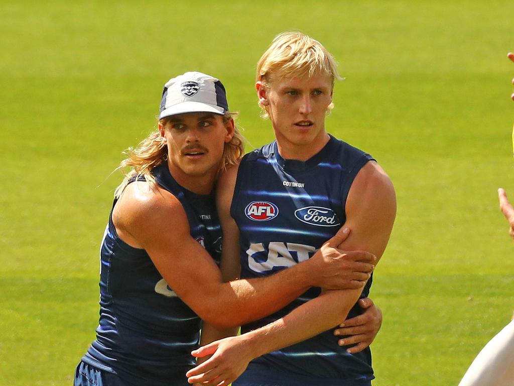 Bailey Smith gives Mitch Knevitt a hug at Geelong Cats training. Picture: Alison Wynd