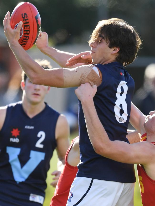 Adam Carafa fires out a handball under pressure.