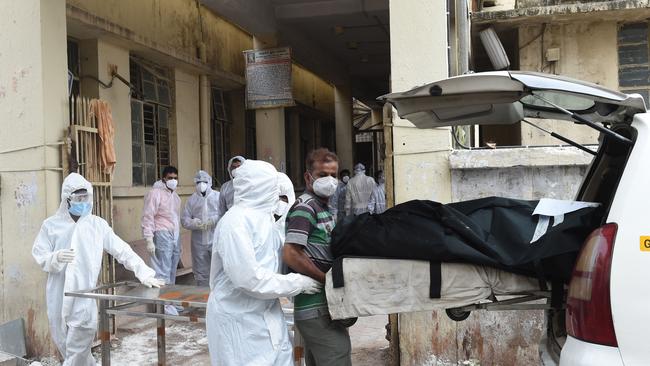 A body is removed from a hospital in Ahmedabad on Thursday after a fire killed eight coronavirus patients. Picture: AFP