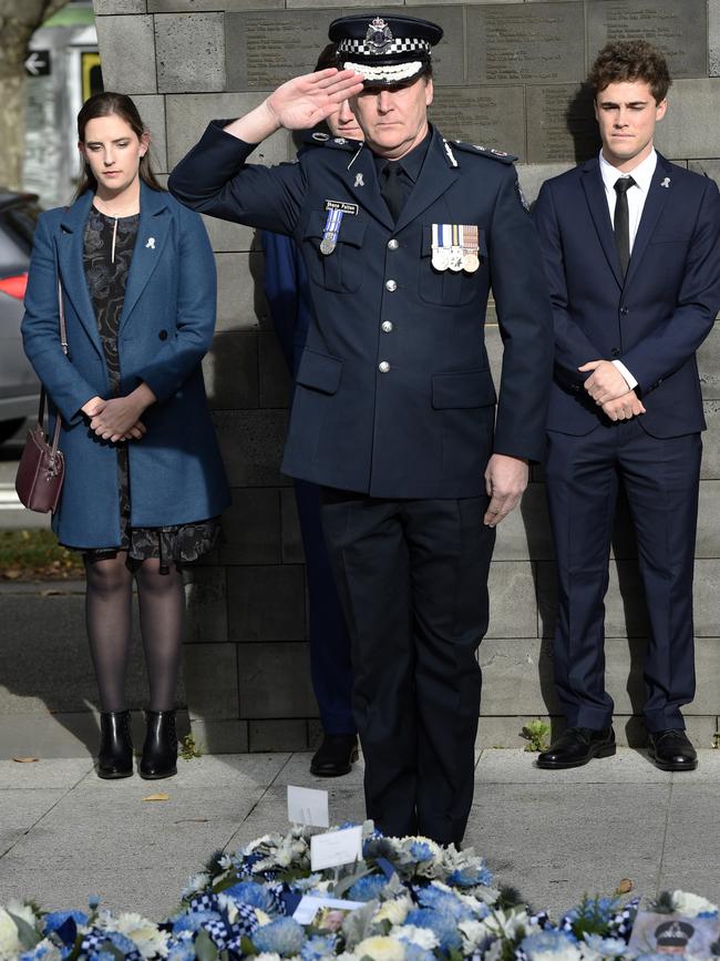 Chief Commissioner Patton salutes the fallen officers.