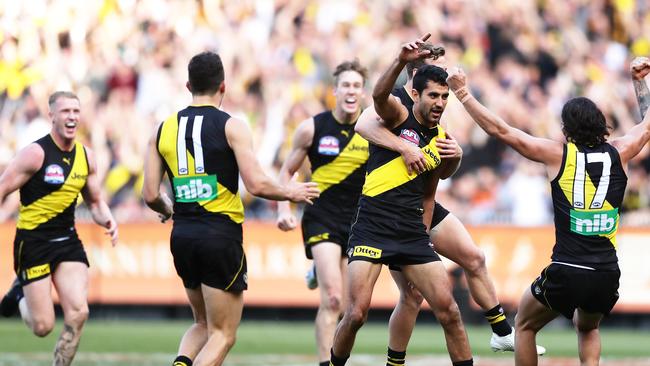 Marlion Pickett is mobbed by teammates after his Grand Final debut goal.