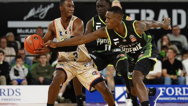 Shannon Scott of the Taipans and Malcolm Bernard of the Phoenix (R) wrestle for the ball during the round two NBL match between SEM Phoenix and Cairns Taipans at John Cain Arena, on October 08, 2022, in Melbourne, Australia. (Photo by Daniel Pockett/Getty Images)