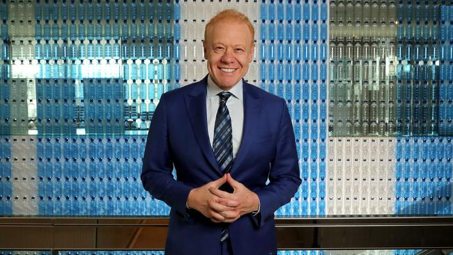 Anthony Pratt in front of a wall of plastic bottles at the Visy office in Melbourne in 2018. Picture: Stuart McEvoy