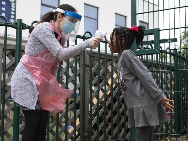 A school staff member takes a child's temperature at a school in London. Picture: Getty