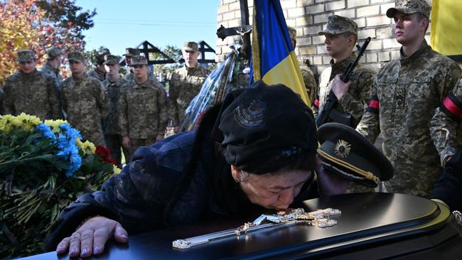 Tetiana Telyzhenko says goodbye to her 44-year-old son Oleksiy Telyzhenko, who disappeared after his capture by the Russians in Bucha in March. Picture: AFP