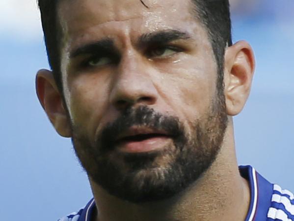 Referee Michael Dean holds a yellow cards after booking both Chelsea's Diego Costa, right, and Arsenal's Gabriel during the English Premier League soccer match between Chelsea and Arsenal at Stamford Bridge stadium in London, Saturday, Sept. 19 2015. Arsenal's Gabriel was sent off moments later for a further clash with Costa .(AP Photo/Alastair Grant)