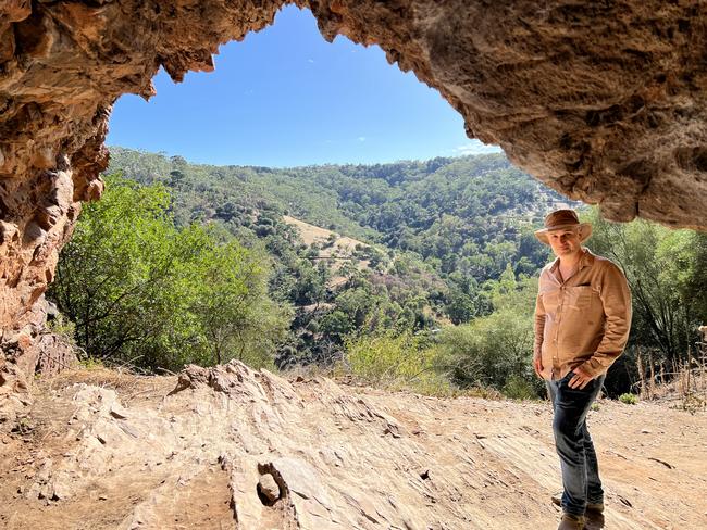 A rock shelter with unknown cultural heritage value, known to climbers as the Bachelor Pad, near Horsnell Gully Conservation Park could be destroyed in the expansion of Hanson's White Rock Quarry. Residents group leader, Demetrios (Jim) Bastiras of Skye at the site. Picture: Clare Peddie