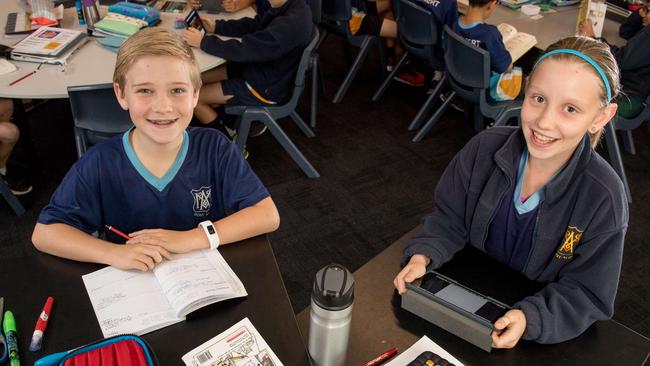 Using a stand-up desk like Flynn Parker and Rebecca Sietzman De Vries can burn 38 kilocalories more per lesson. Picture: Jake Nowakowski