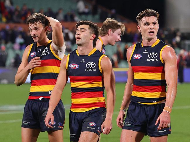 ADELAIDE, AUSTRALIA - JUNE 15: Luke Nankervis of the Crows, Josh Rachele and Ben Keays react as they walk off after the loss during the 2024 AFL Round 14 match between the Adelaide Crows and the Sydney Swans at Adelaide Oval on June 15, 2024 in Adelaide, Australia. (Photo by Sarah Reed/AFL Photos via Getty Images)