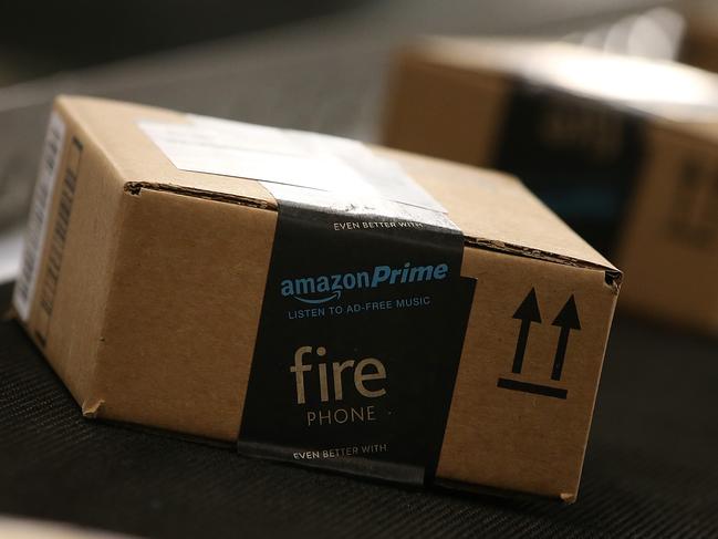 (FILES) This file photo taken on January 19, 2015 shows boxes moving along a conveyor belt at an Amazon fulfillment center in Tracy, California. US online giant Amazon announced plans January 12, 2017 to add 100,000 US jobs over the next 18 months, to bring its American workforce to over 280,000. "These new job opportunities are for people all across the country and with all types of experience, education and skill levels -- from engineers and software developers to those seeking entry-level positions and on-the-job training," a statement from the tech giant said. / AFP PHOTO / GETTY IMAGES NORTH AMERICA / JUSTIN SULLIVAN