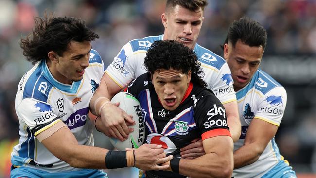 Dallin Watene-Zelezniak of the Warriors is tackled by Tino Fa`asuamaleaui (L), Beau Fermor and Phillip Sami of the Titans on September 3, 2022. TrigonX became a sponsor of the Titans for the 2022 season. Picture: Dave Rowland/Getty Images