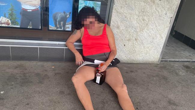 A woman passed out in the street outside Woolworths on Lake St clutching a bottle of booze.