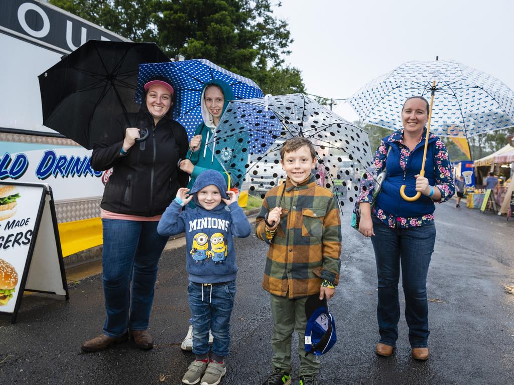 Keeping dry are (from left) Emily Althaus, Edward Woodrow-Althaus, Isabella Woodrow-Althaus, Wiliiam Woodrow-Althaus and Sarah Althaus at the 2022 Toowoomba Royal Show, Friday, March 25, 2022. Picture: Kevin Farmer