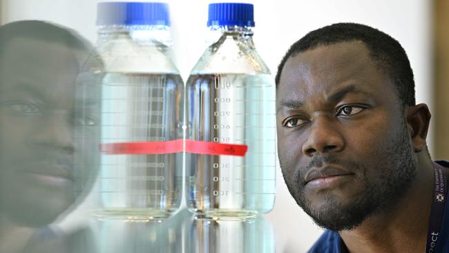 19/4/2024 : Researcher Dr Elvis Okoffo with samples of water he tests fand measures Nanoplastics, in a lab at Queensland Alliance for Environmental Health Sciences (QAEHS) . Nanoplastics are minuscule bits of plastic, measuring less than one micrometre, which is about one sixtieth the size of a grain of salt, so small they've not previously been able to be measured. pic: Lyndon Mechielsen/Courier Mail