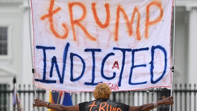 A woman celebrates the indictment of Mr Trump outside the White House on June 9. Picture: Mandel Ngan / AFP