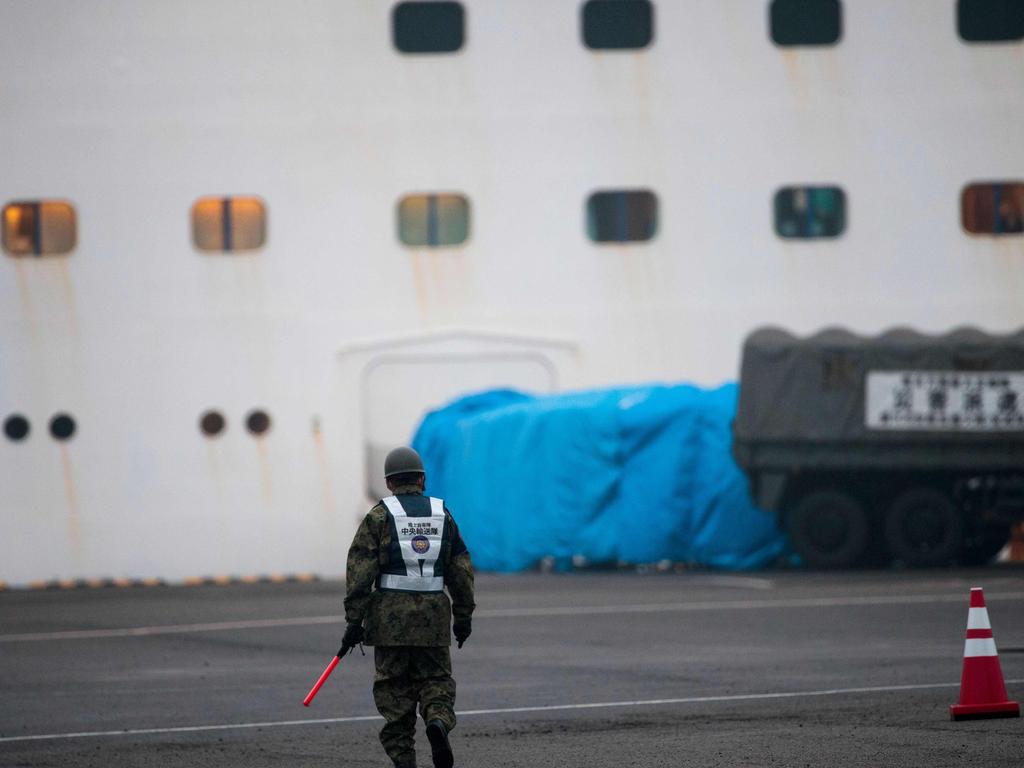 A member of Japan’s defence force patrols near the quarantined Diamond Princess. Picture: Behrouz Mehri/AFP