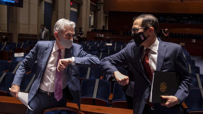 US Federal Reserve chairman Jerome Powell (left) and Treasury Secretary Stephen Mnuchin bump elbows at the conclusion of the House Committee on Financial Services hearing this week in Washington. Picture: AFP