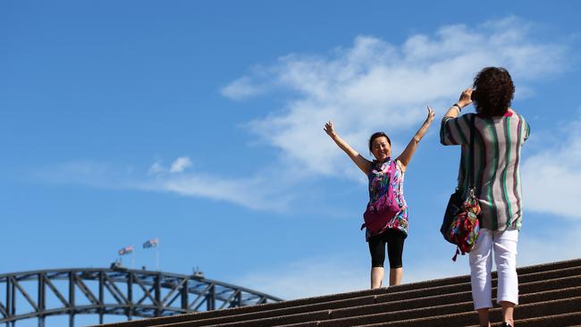 Chinese tourists take photographs in front of the Sydney Harbour Bridge. Picture: Getty Images