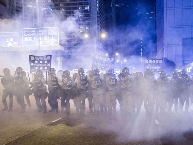 Police in a cloud of teargas. Pic: AFP.