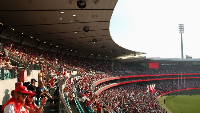 Footy fans enjoy the sunshine at the SCG on Saturday, despite the deafening music. Picture: Getty Images