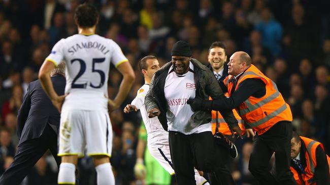 LONDON, ENGLAND - NOVEMBER 27: Roberto Soldado of Spurs attempts to tackle a pitch invader as stewards apprehend him during the UEFA Europa League group C match between Tottenham Hotspur FC and FK Partizan at White Hart Lane on November 27, 2014 in London, United Kingdom. (Photo by Ian Walton/Getty Images)