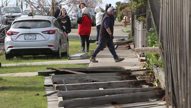 Residents survey the damage in Ironbark St, Waurn Ponds. Picture: David Crosling