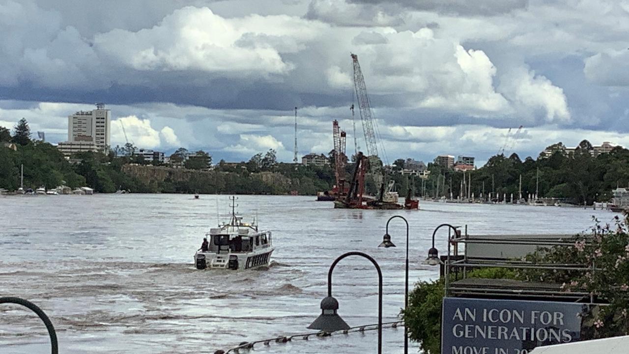 A crane on a pontoon has broken free and is floating down Brisbane River, causing evacuations of Howard Smith Wharves. Picture: Queensland Police