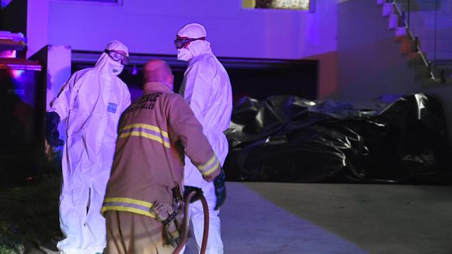 Fire and Rescue HAZMAT teams at the house in Oatlands last night. Picture: Gordon McComiskie