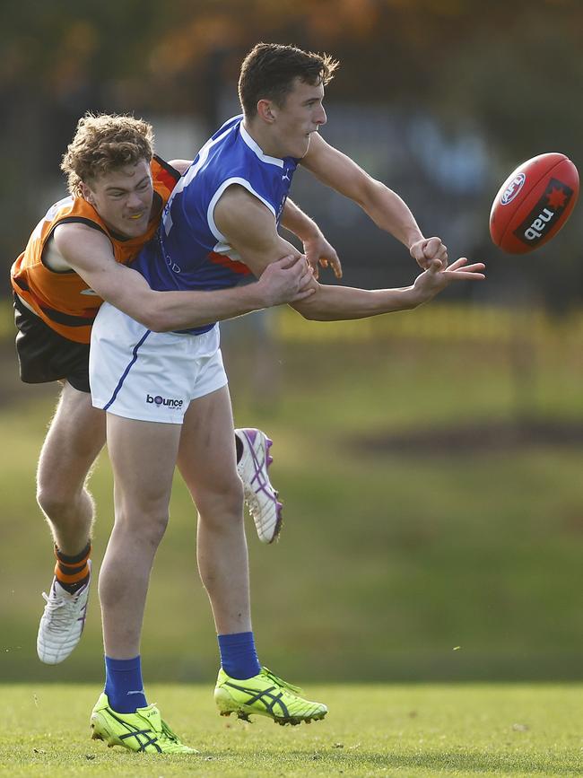 Lachlan Reidy of the Ranges handballs.