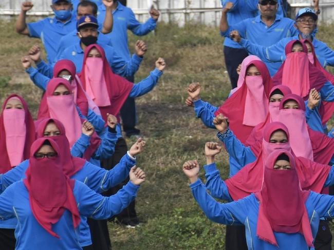 Female civil servants conduct group morning exercises in Lombok. Picture: AFP