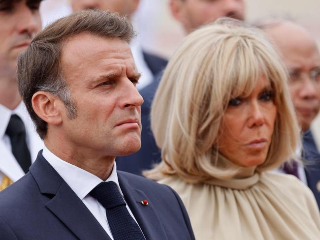 France's President Emmanuel Macron (L) and his wife Brigitte Macron take part in a wreath-laying ceremony at the monument of national heroes and martyrs in Hanoi on May 26, 2025. Picture: AFP
