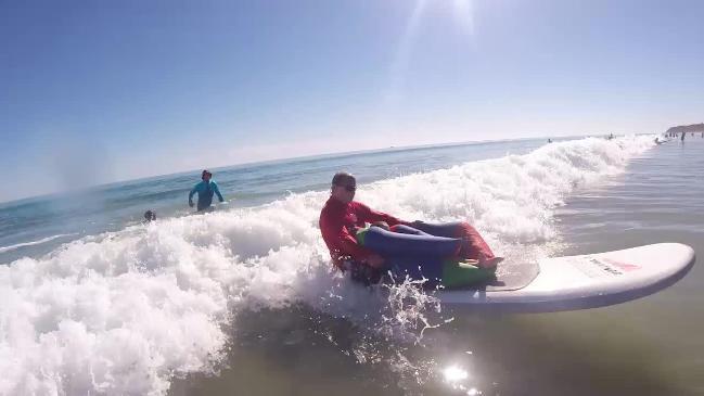 Riding the waves at Moana Beach with the Disabled Surfing Association of SA