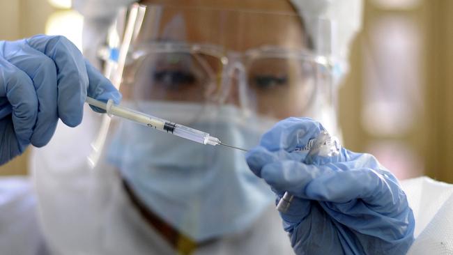 Canberra Airport chief executive Stephen Byron says there’s ‘a complete lack of urgency’ to get vaccinated in Australia because governments haven’t agreed to incentives. Picture: AFP