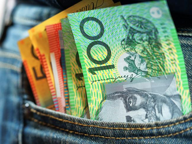 Australian cash money in mans jeans pocket, close up.