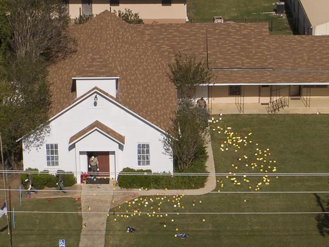 Flags mark evidence on the lawn of the First Baptist Church in Sutherland Springs, Texas. Picture: Jay Janner/Austin American-Statesman via AP