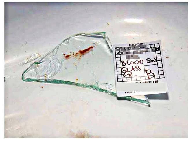 NEW UPSIZED: A broken shard of glass with a red smear labelled "blood" by police. The Queensland government's DNA testing laboratory initially found "insufficient DNA for further testing".