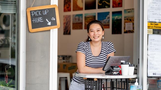 The NT’S Chamber of Commerce boss has called on the Gunner Government to allow businesses to begin reopening in as little as three weeks, as Monday marked a week without any new COVID-19 cases in the Territory. Pictured is Darwin’s Kopi Stop owner Jules Mou at her makeshift takeaway-only coffee stall, set up after the rollout of social distancing restrictions on cafes. Picture: Che Chorley