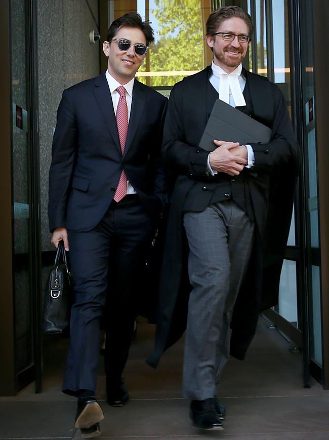 Journalist Joe Aston (left) leaves the Federal Court with his lawyer. Picture: Jane Dempster