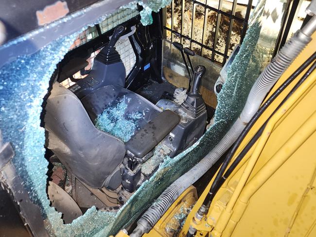 Activists smashed excavator cab window