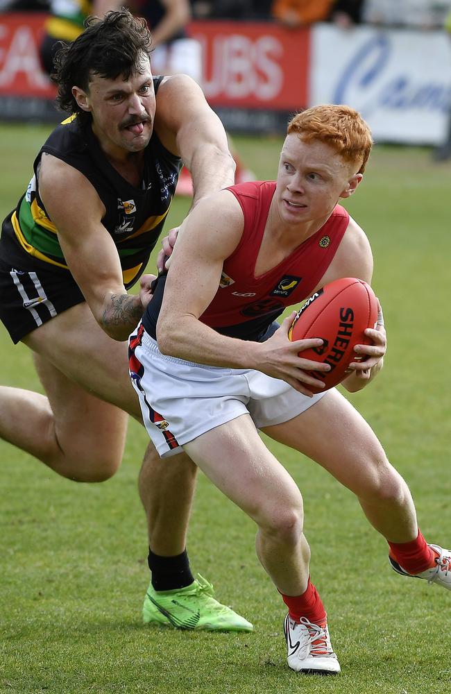 William Lambert with the ball, ahead of Dromana’s Luke Oborn. Picture: Andrew Batsch