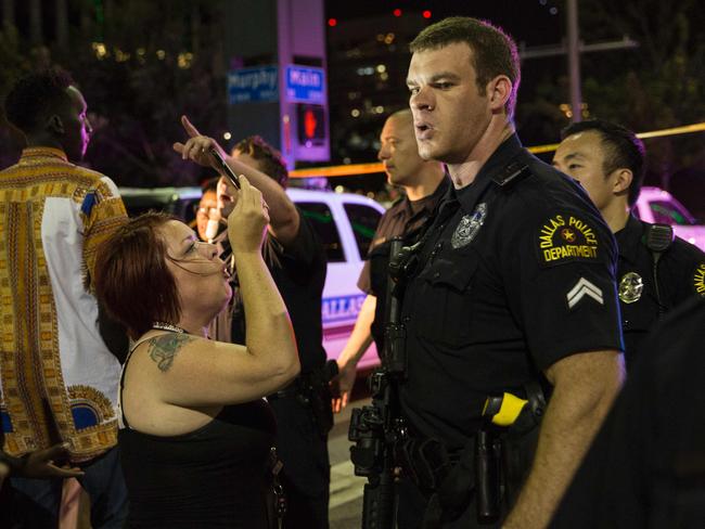 Police attempt to calm the crowd after snipers shot police in Dallas. Picture: AFP/Laura Buckman