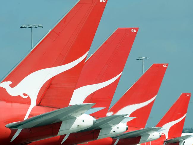 **FILE** A Dec. 3, 2008 file photo of the tails of Qantas jets at Sydney International Airport. Qantas Airways Ltd's first-half profit slumped 66 per cent, Wednesday, Feb. 4, 2009, as fuel and labour costs buffeted Australia's biggest airline. (AAP Image/Dean Lewins,File) NO ARCHIVING