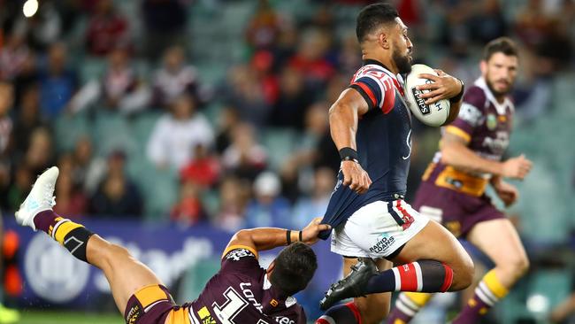 Isaac Liu on the charge for the Roosters against the Broncos at Allianz Stadium.