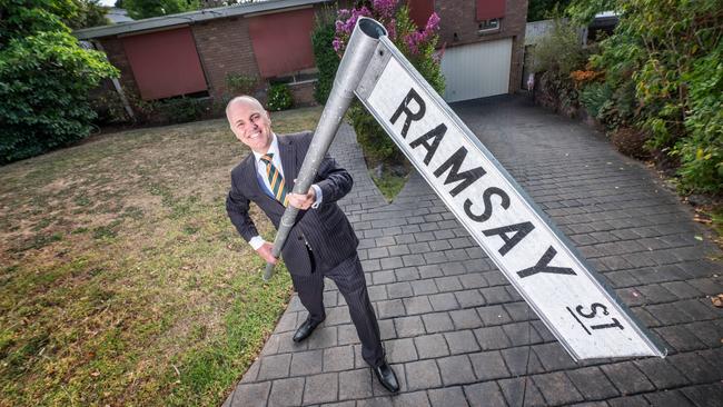 MJ Docking Real Estate director Adam Docking with a Ramsay St sign at a home in Pin Oak Court, which is used for filming of Neighbours. Picture: Tony Gough