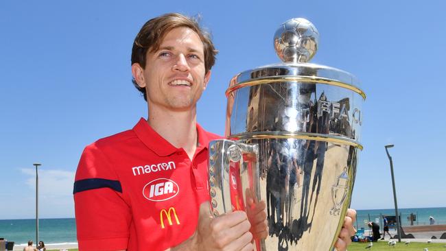 Adelaide United’s former winger Craig Goodwin with last year’s FFA Cup trophy at Henley Beach. Picture: AAP Image/David Mariuz