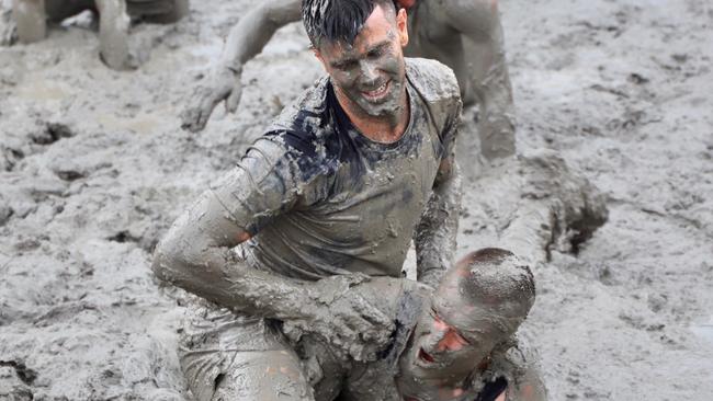 Trent Cotchin and Dusty Martin take part in the mud-filled obstacle course. Picture: Molly Stapleton/Richmond FC