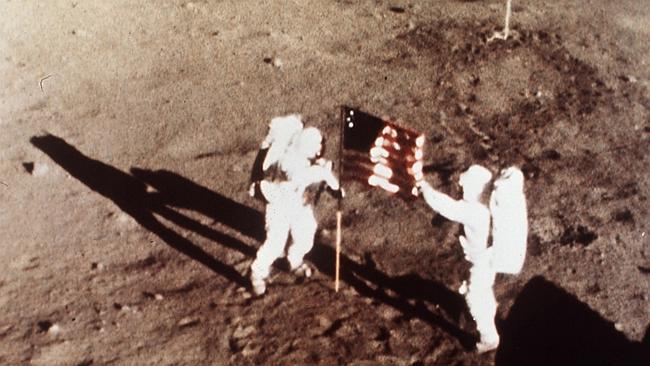 ** FILE ** In this July 20, 1969 file photo, Apollo 11 astronauts Neil Armstrong and Edwin E. "Buzz" Aldrin, the first men to land on the moon, plant the U.S. flag on the lunar surface. The National Aeronautics and Space Administration, which opened its doors on Oct. 1, 1958, is struggling with its identity and its future. Its angst is connected to the vehicle that NASA has been married to for more than half its lifetime and is seeking to dump the space shuttle. (AP Photo/NASA, File)