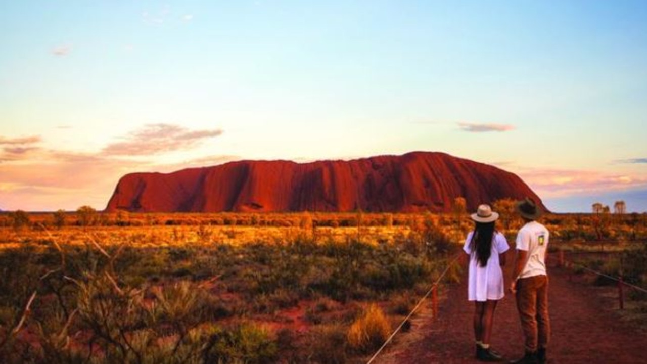 One of the great natural wonders of the world, Uluru towers above the surrounding landscape.